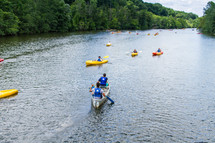paddling down a river in canoes and kayaks 