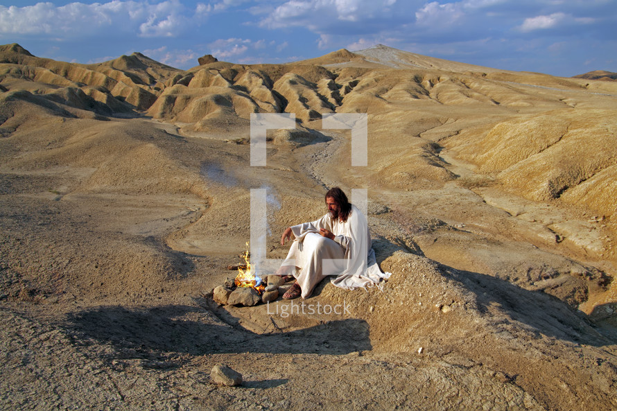Jesus meditating alone in a desert. Biblical concept.
