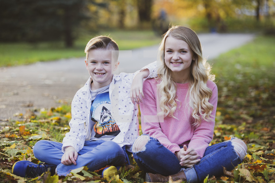 brother and sister outdoors in fall 
