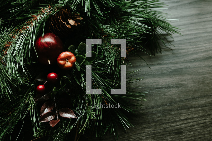 Rustic Christmas garland on a dark wood background