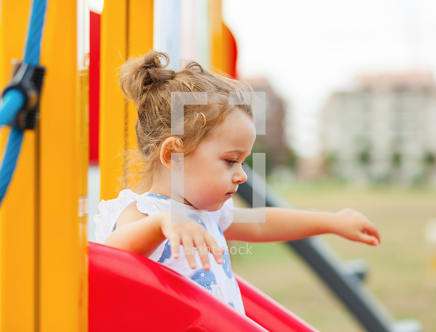 toddler girl on a slide 