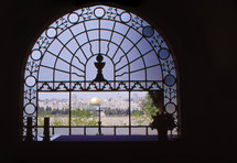 stained glass window and a view of The Dome of the Rock 