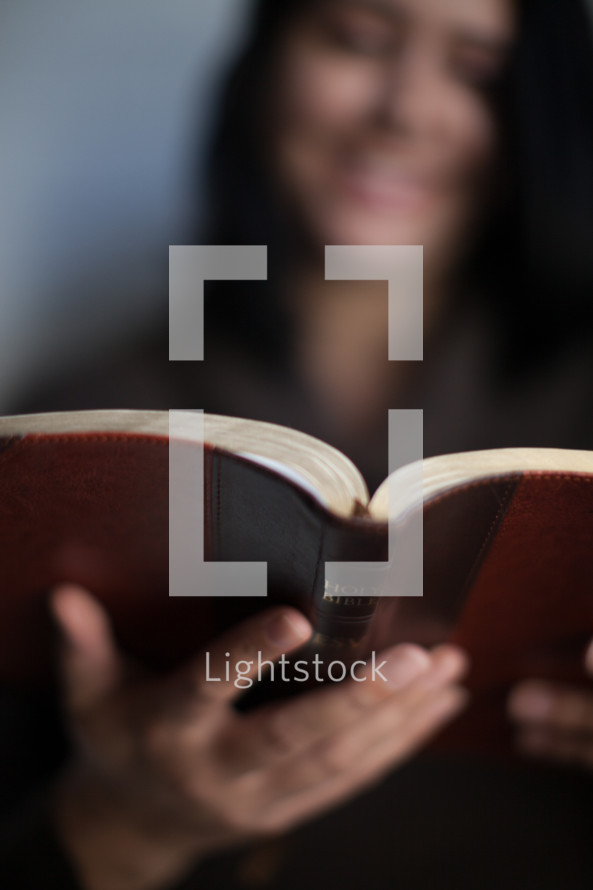 Latino woman reading a Bible 
