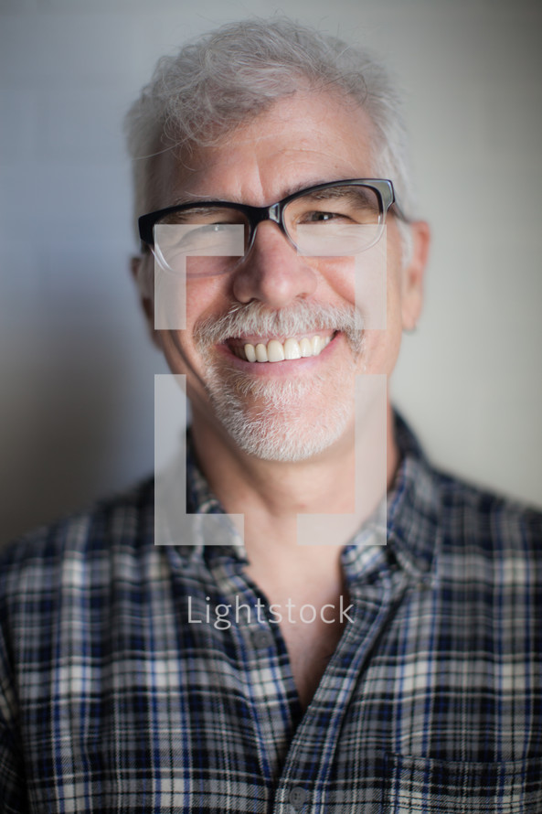 face of a man with reading glasses 
