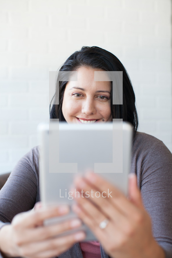 woman looking at an iPad screen 