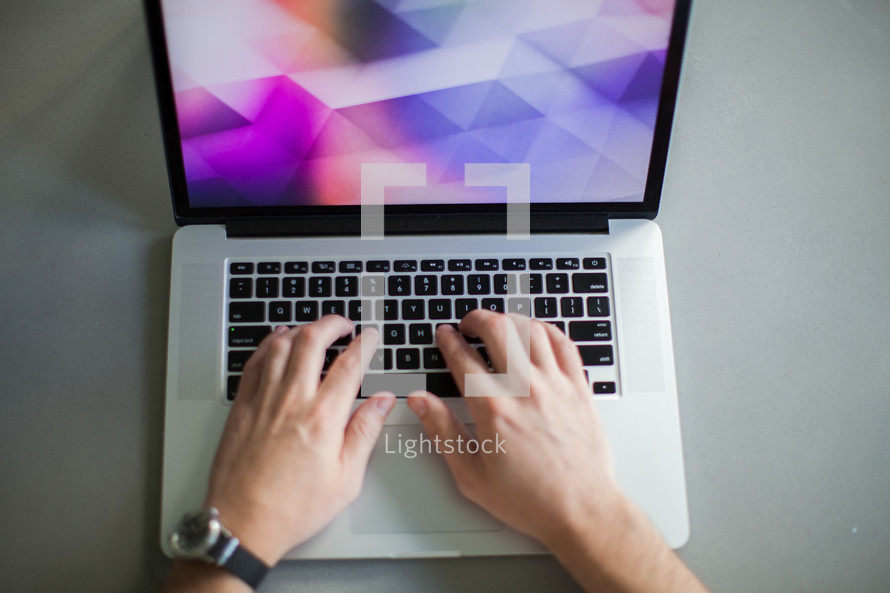 man's hands on a laptop computer 