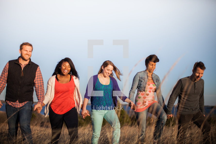 group of people walking holding hands in fellowship 