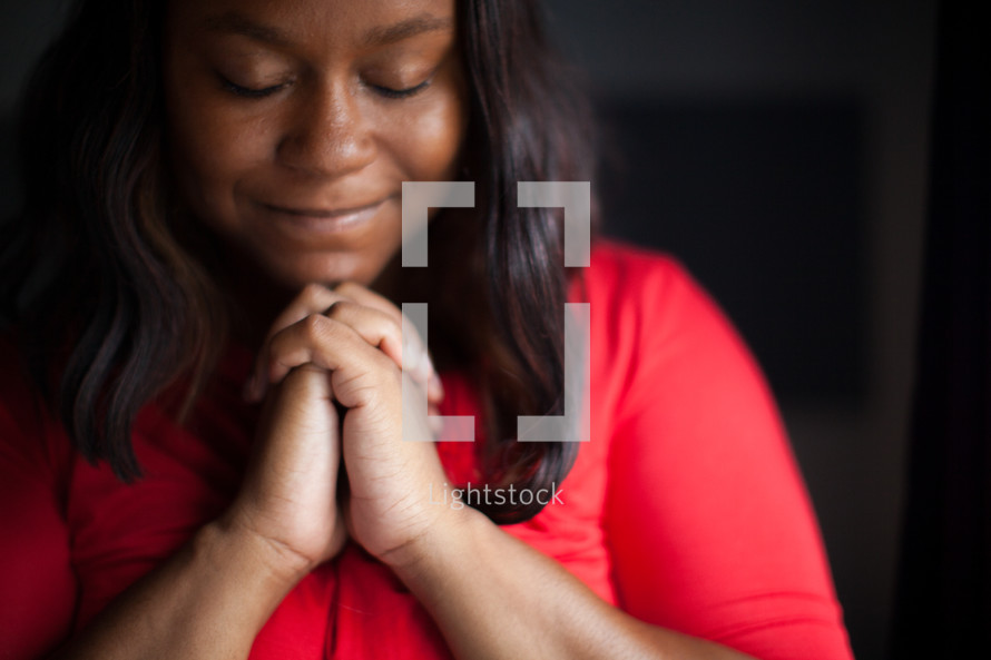 African-American woman with praying hands 