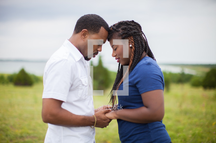 happy African-American couple holding hands 