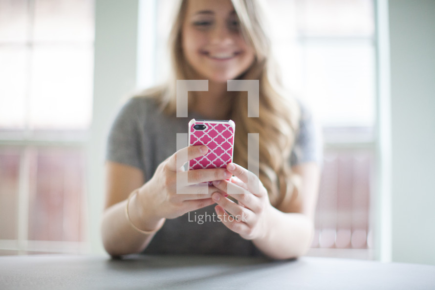 woman looking at a cellphone screen 