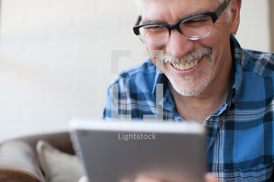 man looking at an iPad screen 