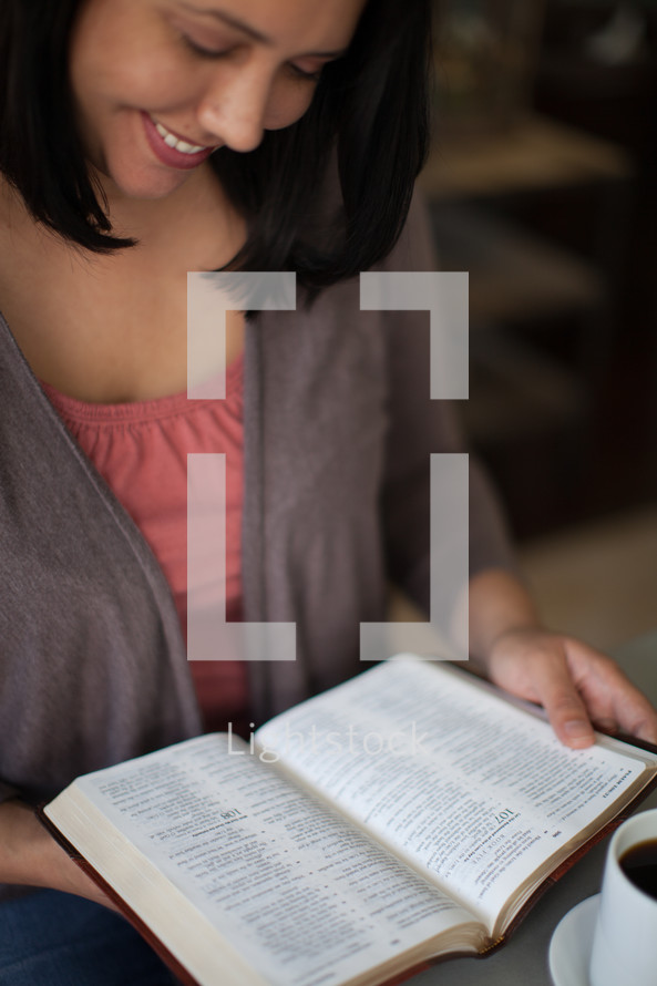 Latino woman reading a Bible 