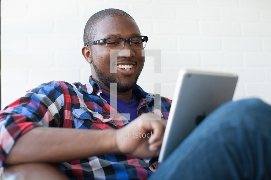 man looking at an iPad screen