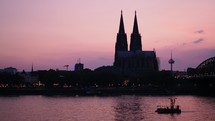 Skyline of Koelner Dom gothic cathedral church at sunset in Koeln, Germany