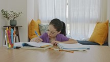 Frustrated young girl trying and failing to prepare homework for school