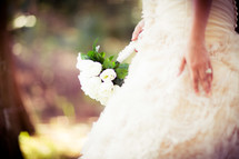 torso of a Bride holding a bouquet at her wedding
