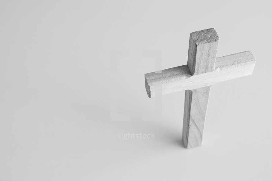 black and white image of wooden cross on a white background