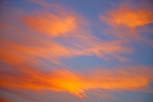 orange clouds in a blue sky at sunrise 