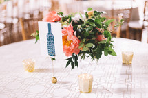 flower arrangement in the center of a table at a wedding reception 