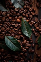 Coffee beans with leaves on a rustic wood background