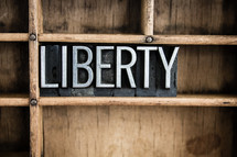 word liberty on a shelf 