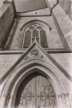 wood doors and arched windows on a cathedral 