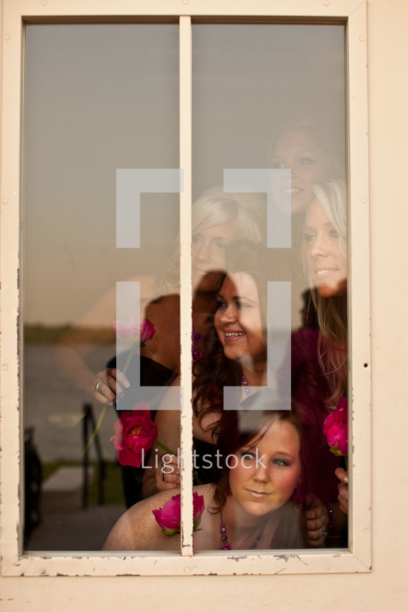 bridesmaids looking out a window