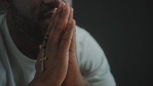 Religious Black Man Holding Cross and Praying to God