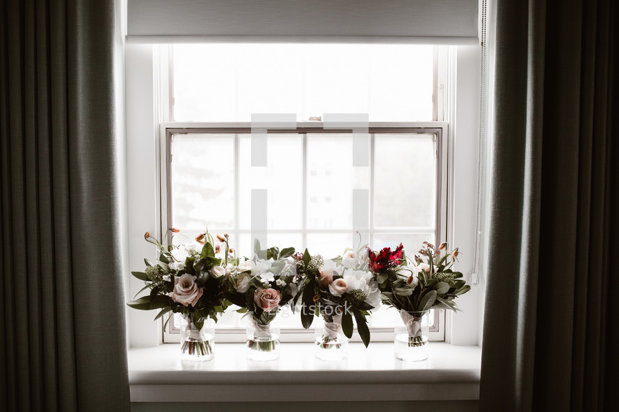 bridal bouquets in a window sill 
