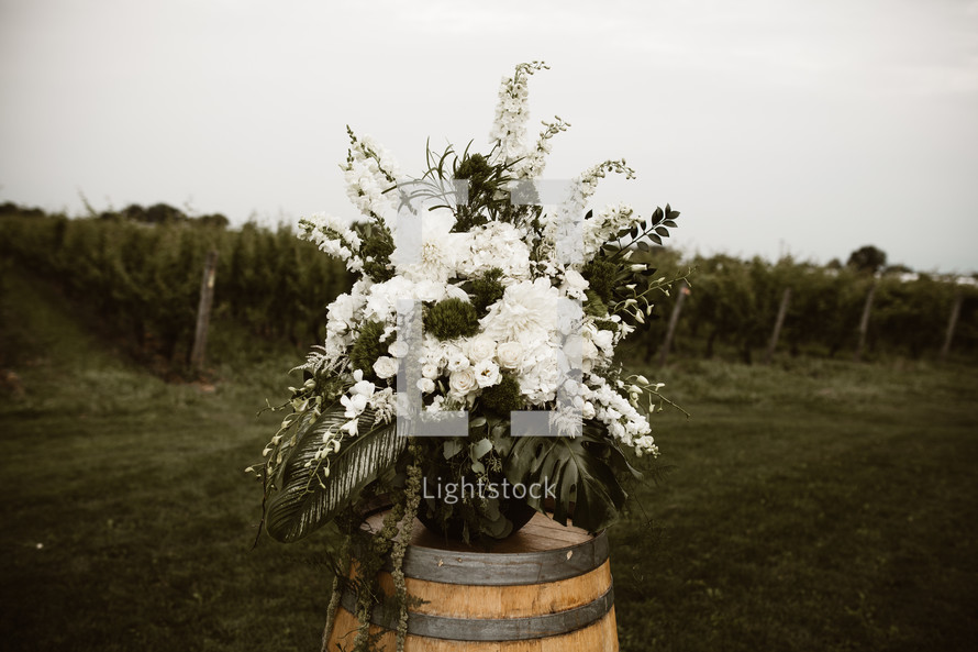 flower arrangement on a wine barrel 
