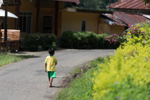 boy walking on the streets of Toraja 