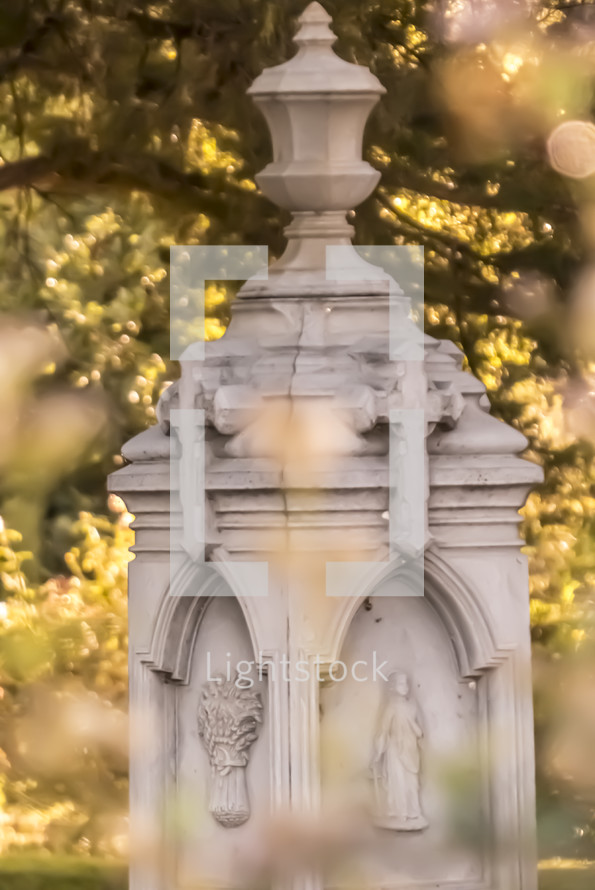 defocused grave monument with bokeh effects