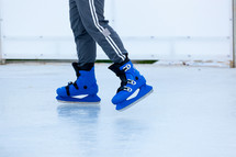 Blue ice skates on ice