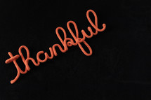 word thankful in rope on a black background 