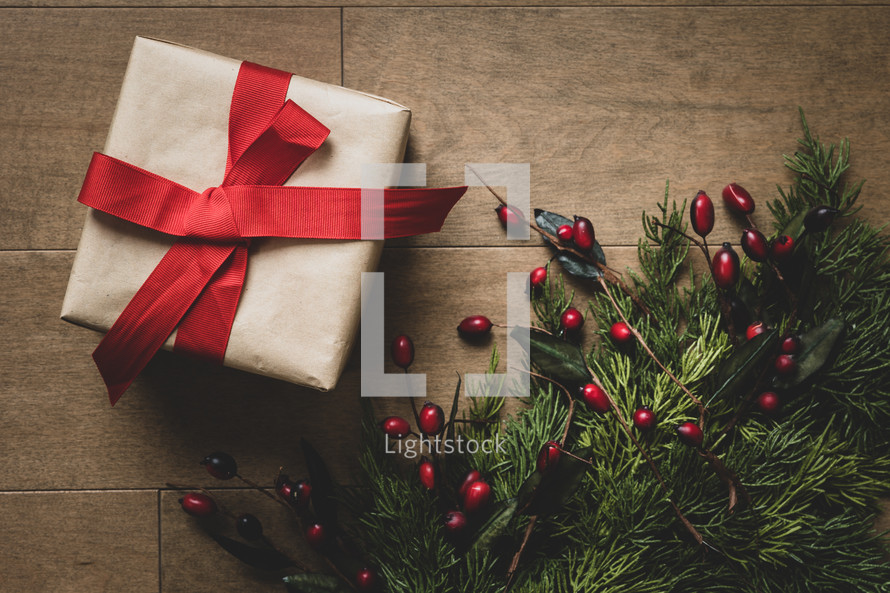 gifts and evergreen branches on a wood background 