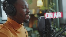 Black Man Singing to Guitar during Radio Program in Broadcasting Studio
