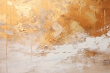 Abstract gold paint on beige wall background