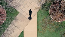 Overhead view of woman walking across college campus