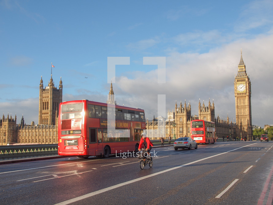 LONDON, ENGLAND, UK - OCTOBER 23: Double decker bus crossing the world famous Westminster Bridge in front of the Houses of Parliament on October 23, 2013 in London, England, UK
