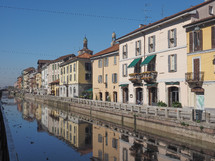 MILAN, ITALY - MARCH 28, 2015: Tourists at the Naviglio Grande canal waterway in Milan Italy