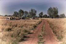 abandoned vehicles along a dirt road in Australia 