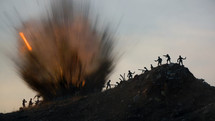 Miniature silhouettes of WWII American and German soldiers fighting under big explosion.
