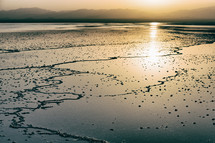 sunset on the shore of a salt lake 