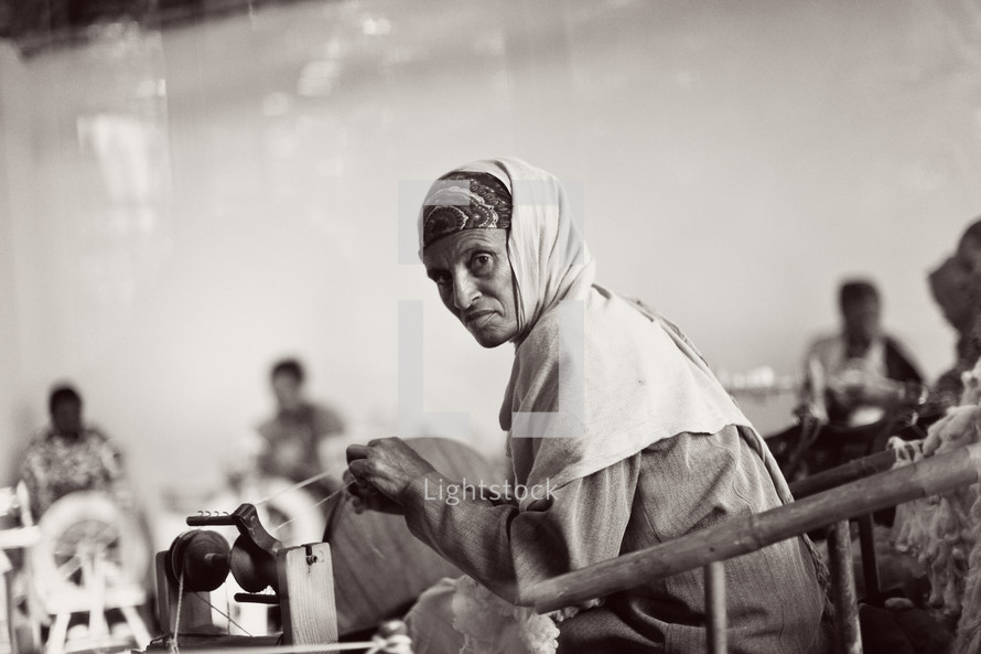 woman sewing at a sewing machine in a factory