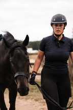 Horse in hand, equestrian woman with a pony, beautiful horse riding equine girl