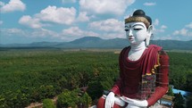 Aerial Massive Buddha Statue Asia Countryside Pull Back Drone