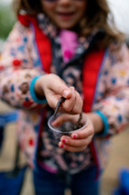 Little girl's hands holding a worm 