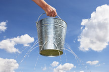 Man holding bucket with holes leaking water