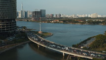 Road bridge over the river with traffic in Ho Chi Minh city during the day. Aerial shot made with flying drone
