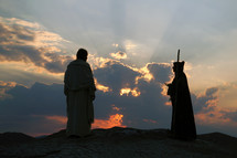 Jesus and Satan at dusk on a hill in the Wilderness of Judea - Israel.

